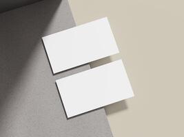A simple business card mockup placed on a beige cement surface with a sleek shadow, ideal for showcasing minimalist brand logos. photo