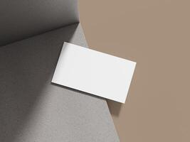 Business card mockup displayed on a grey cement block with soft lighting, creating an elegant backdrop for a professional design. photo