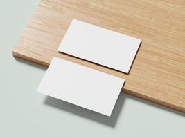 A pair of white business cards on a wooden surface, subtly angled to create an elegant and modern visual effect. photo