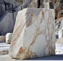 A large white marble block sitting on top of a large rock photo