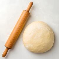 Fresh Raw Dough and Rolling Pin Isolated on White photo
