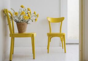 Two yellow chairs are placed next to each other in a room with a white wall photo