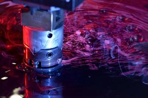close up view of the machine working on liquid with red and blue illumination photo
