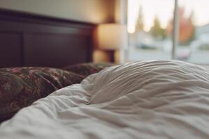 Soft bedding in a cozy room with morning light shining through the window photo