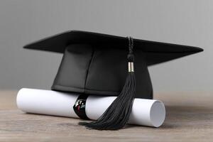 Graduation cap and diploma rolled on a wooden table in a modern setting photo