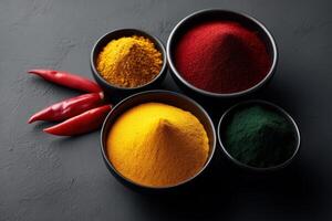 Spices arranged in bowls with red chili peppers on a dark surface for culinary inspiration photo