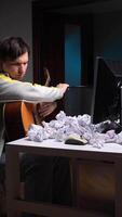 vertical Young man emptying crumpled paper from bin onto computer keyboard video