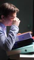 vertical close-up Office worker struggling with excessive paperwork at computer desk video