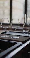 Clean wine glasses are on the table of a special wine cabinet, stylish table setting, ice, bottle of sparkling wine, light from window, decoder and degasser video