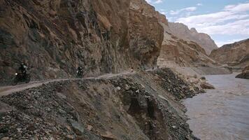 Group of Motorcyclists Ride Over River in Himalayas video