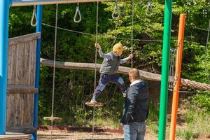 Child Balancing on Adventure Playground Equipment photo