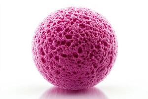 Bright pink sponge ball on a reflective surface showcasing texture and color details photo