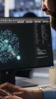 Vertical Exhausted computer scientist in server room reviewing neural network outputs, suffering from mental fatigue. Stressed data center IT expert analyzing AI LLM visualization, camera A video