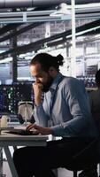 Vertical Angry data center engineer banging fist on desk after seeing system failure. Server farm IT expert reacting furiously to unstable infrastructure performance, leaving office, camera A video