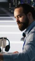 Vertical Server hub worker arranging desk objects to optimize efficiency during tasks. Data center system administrator reorganizing desk items to streamline workflow and boost productivity video