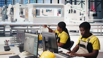 Black employee manages solar panel configuration via desktop tools, optimizing factory output and troubleshooting. Technician updates energy system parameters on pc. Camera B. video