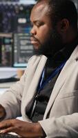 Vertical Cheerful data center admin pleased after finalizing neural network software build upgrade. Joyous server hub IT specialist smiling after seeing at stable infrastructure performance, camera A video