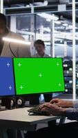 Vertical Data center admin using isolated screen mockup PC to update storage arrays software, configuring network virtualization. Server room IT expert using chroma key computer to verify settings, camera A video