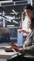 Vertical Happy data center manager pleased by work done by team integrating AI automation tools in infrastructure maintenance. Smiling supervisor satisfied by worker upgrading machine learning models, camera A video