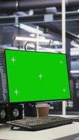 Vertical Mockup computer in high tech data center office used for AI system monitoring and performance tracking. Green screen PC overseeing server rigs involved in computing operations video
