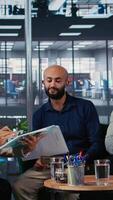 Vertical Team of multicultural associates engaging in strategic thinking for a partnership, showcases corporate leadership skills with focus on foresight and research. Career development in office. Camera A. video