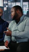Vertical Business meeting in corporate office involving executive decision making, strategic thinking and planning. Diverse professionals ensure organizational growth and performance metrics. Camera B. video