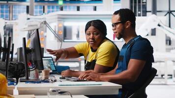 Factory workers team check solar energy system diagnostics on PC, using analytical tools and CAD software. Technicians detecting faults and finetuning automation for renewable energy. Camera A. video