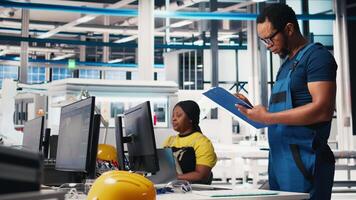 Portrait of engineer in photovoltaics factory reviewing paperwork to diagnose malfunctioning systems. Solar panels plant worker reading inspection data files to reduce downtime. Camera B. video