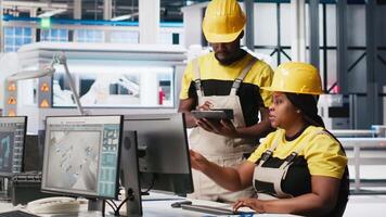 African american team of employees doing quality control on pc, troubleshooting and fixing technical issues for solar panel production at the factory. Coworkers inspecting system. Camera A. video