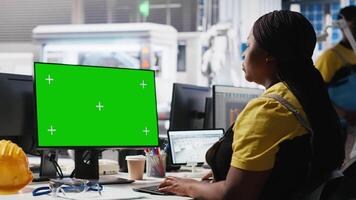 Black woman working in photovoltaics factory using copy space on PC to improve solar panels assembly processes. Assembly line engineer using mockup computer to calibrate equipment. Camera A. video