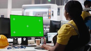 Photovoltaics facility worker reviews data on green screen computer to improve production, eco friendly solar energy. Solar panels plant expert identifying system errors using mockup PC. Camera A. video