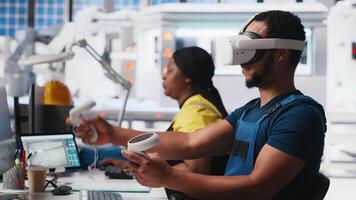 African american technician in solar panels plant using VR goggles, optimizing layouts using CAD software. Photovoltaics factory worker using virtual reality tech to do arrangements. Camera A. video