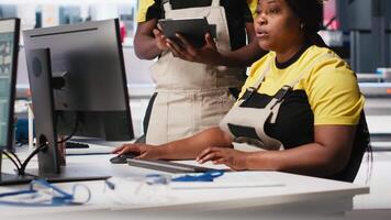 Black employees analyzing production line solar panels in the photovoltaics factory, analyzing data. Manufacturing plant engineers reading documentation files to troubleshoot errors. Camera A. video