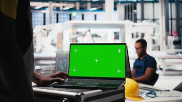 Black photovoltaics factory manager using isolated PC to optimize production of solar cells, renewable energy. Solar panels plant supervisor monitors manufacturing process on computer. Camera B. video