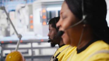 Customer support black engineer at help desk in photovoltaic facility answering calls on headset, offering assistance and support in fixing technical issues. Female operator on help line. Camera A. video
