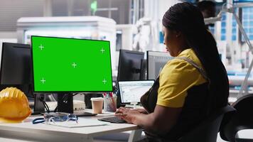 Solar panels plant engineer overseeing energy consumption using isolated screen PC. Photovoltaics facility employee ensuring optimal use of manufacturing resources using monitor. Camera A. video