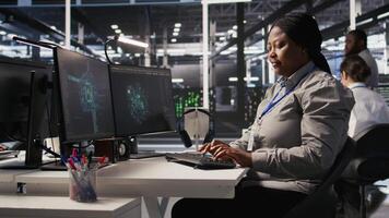 Woman in data center doing software updates, verifying machine learning parameters. Server farm IT expert using PC to inspect configurations, ensuring optimal application performance, camera A video