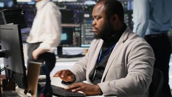 Cheerful data center admin pleased after finalizing neural network software build upgrade. Joyous server hub IT specialist smiling after seeing at stable infrastructure performance, camera A video