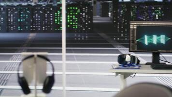 Close up of data center PCs showing deep learning visualization debugging tools. Computer systems in server hub powering artificial intelligence and automated research tasks, handheld camera shot video