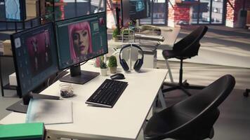 Professional studio setup for content and photography editing. Empty workspace with monitors displaying retouching software, supports creative careers in visual design. video