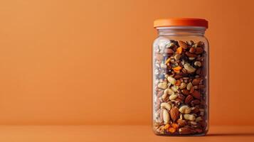 A glass jar filled with nuts and seeds photo