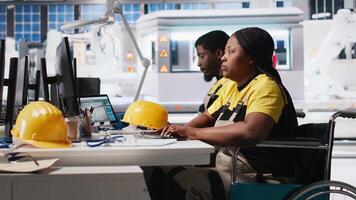 Woman with disability works in photovoltaics factory on designing solar cells, debugging and fixing malfunctioning systems. Plant worker wheelchair user ensuring operational reliability. Camera A. video