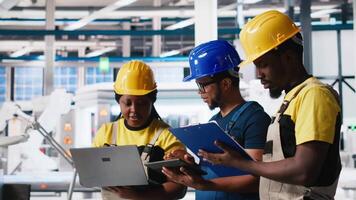 Solar panels engineers team developing new photovoltaic materials using devices in the manufacturing plant. Black workers group conducting experiments for better production line. Camera A. video