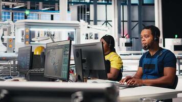 Call center technician handling maintenance inquiries in solar factory, working in customer service industrial tech support. African american operator on headset with clients. Camera B. video