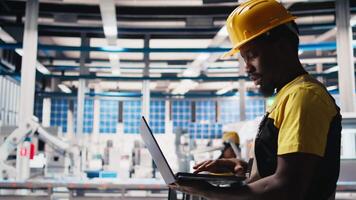 Engineer using laptop to monitor solar panel plant assembly lines, troubleshooting photovoltaic equipment to ensure seamless production workflow. Automation for alternative energy. Camera B. video