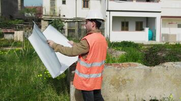 Architect On The Construction Site While Analyzing The Project Map video