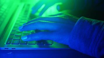 Engaging in coding under neon lights at night, cyber crime concept video