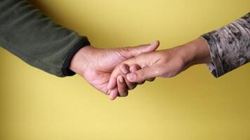 Hands connecting in a warm embrace at a cozy setting video