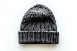 Warm knitted beanie resting on a light background for winter fashion enthusiasts photo