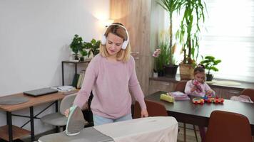 Joyful family moments while ironing and playing in a cozy home setting after school hours video